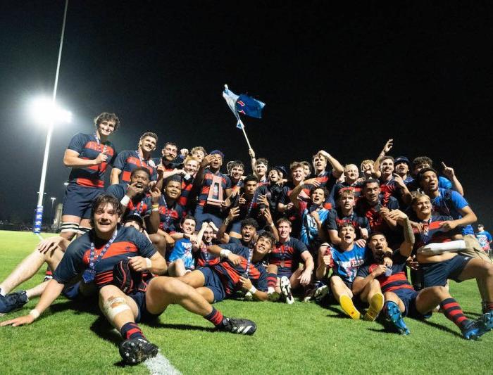 SMC Men's Rugby poses for a group photo on the pitch after winning 2024 National Championship